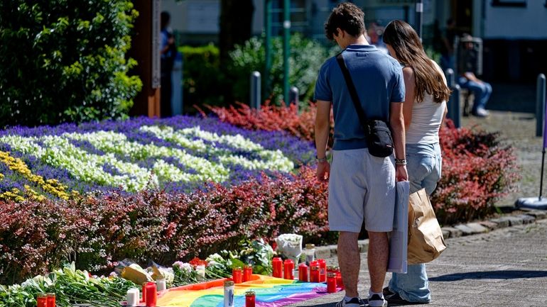 People lay flowers near the scene of a knife attack...