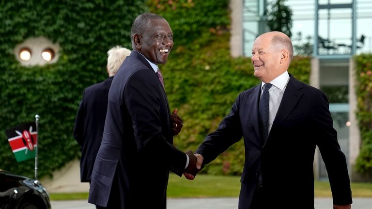 German Chancellor Olaf Scholz, right, welcomes Kenya's President William Ruto...