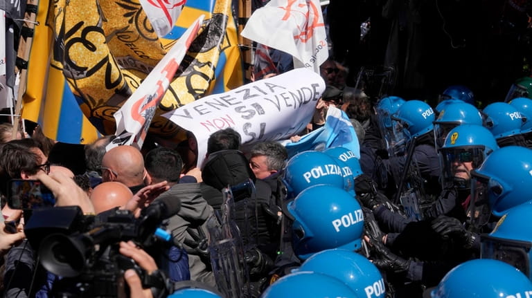 Citizens and activists confront police during a demonstration against Venice...