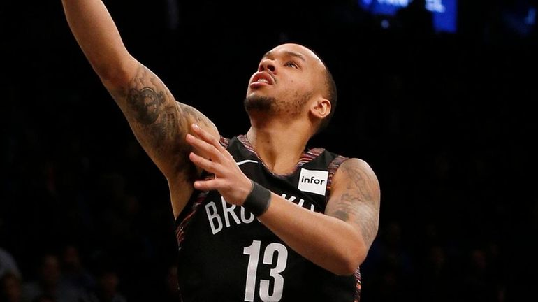 Shabazz Napier of the Nets goes to the hoop against...