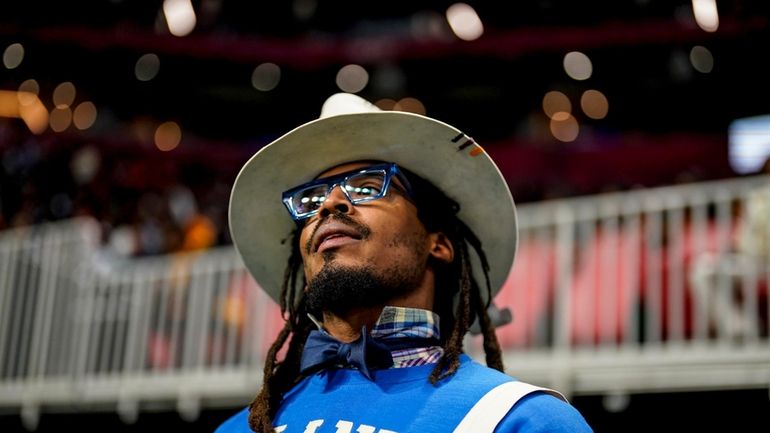 NFL football player Cam Newton watches play between Howard and...