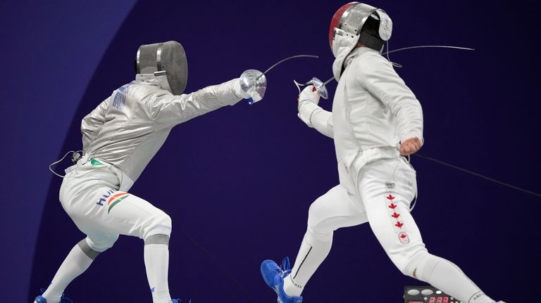 Hungary's Aron Szilagyi, left, and Canada's Fares Arfa compete in...