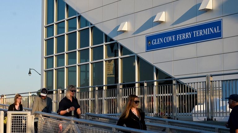 Manhattan-bound commuters board a ferry at the Glen Cove Ferry Terminal...