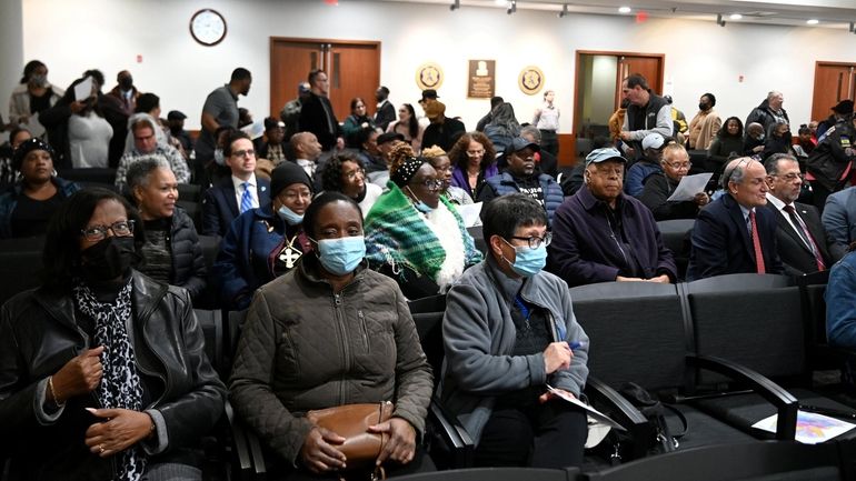 People gather at a hearing to comment on two county legislative...