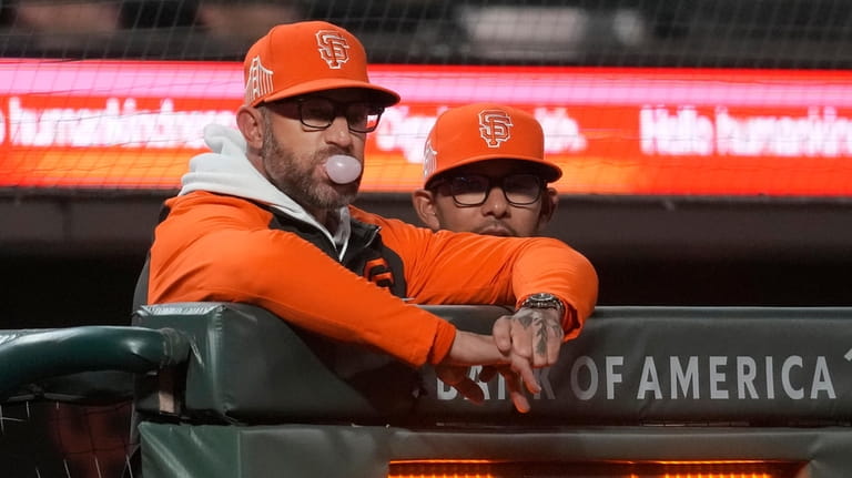 San Francisco Giants manager Gabe Kapler, left, watches from the...