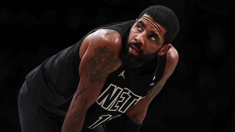 Kyrie Irving #11 of the Brooklyn Nets looks on during...