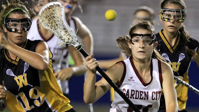 Garden City's Mariah Pewarski looks to control ball in 1st...