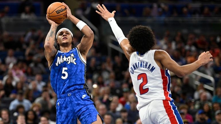 Orlando Magic forward Paolo Banchero (5) shoots as Detroit Pistons...