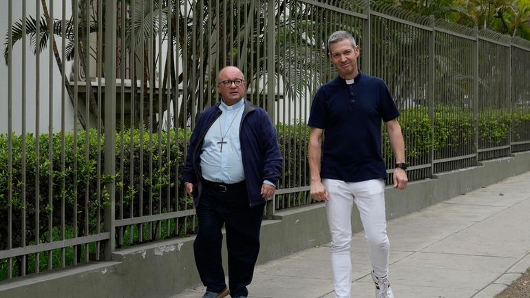 Vatican investigators, Archbishop Charles Scicluna, from Canada, left, and Monsignor...