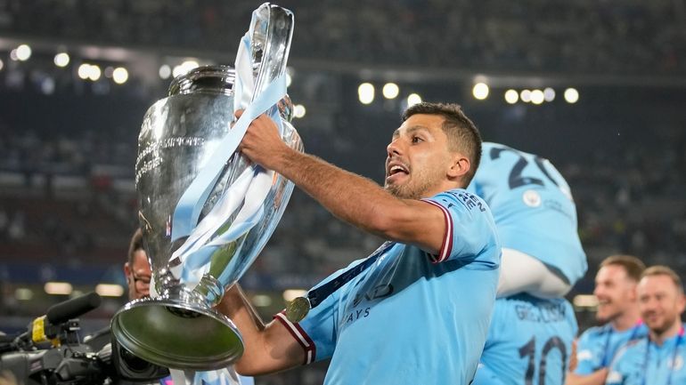 Manchester City's Rodrigo holds the trophy after the Champions League...