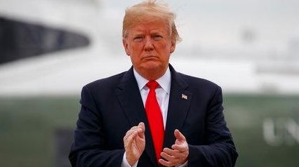 President Donald Trump boards Air Force One for a trip...