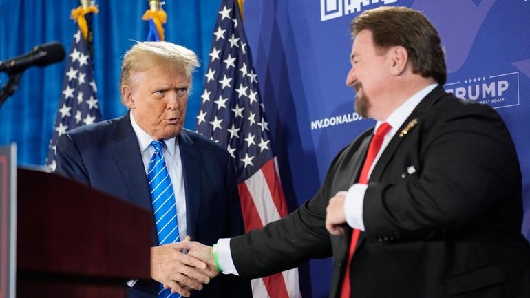 Nevada GOP chair Michael McDonald, right, shakes hands with Republican...