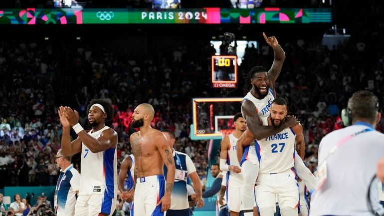 Team France celebrates after beating Germany during a men's semifinals...