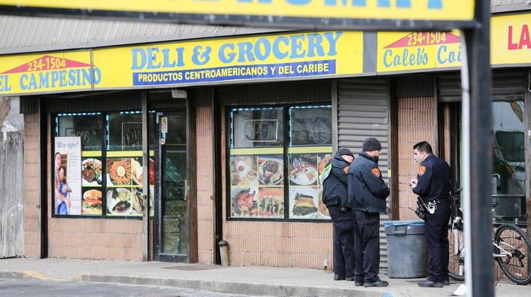 Police investigate the shooting at El Campesino Deli & Grocery at...