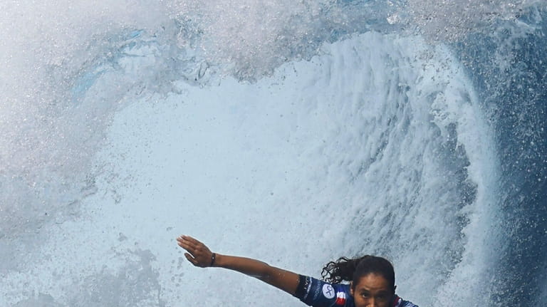 Surfer Vahine Fierro of France competes on her way to...