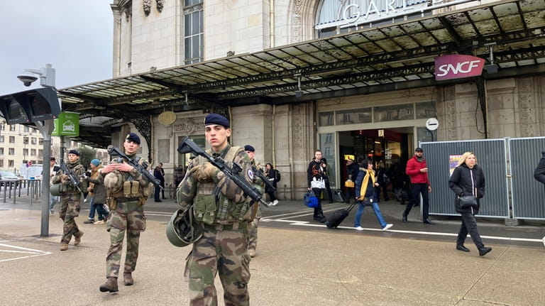 Soldiers patrol outside the Gare de Lyon station after an...