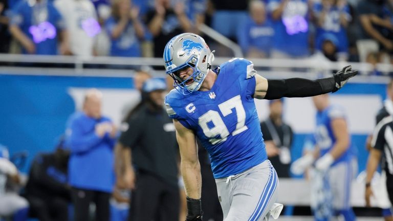 Detroit Lions defensive end Aidan Hutchinson (97) celebrates his sack...