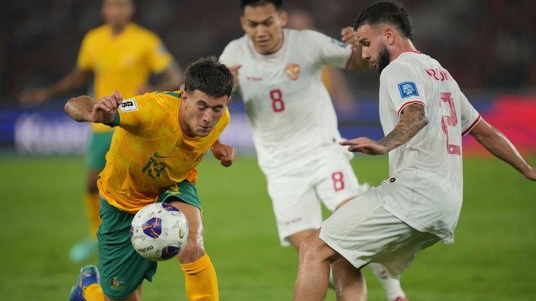 Australia's Alessandro Circati, left, battles for the ball against Indonesia's...