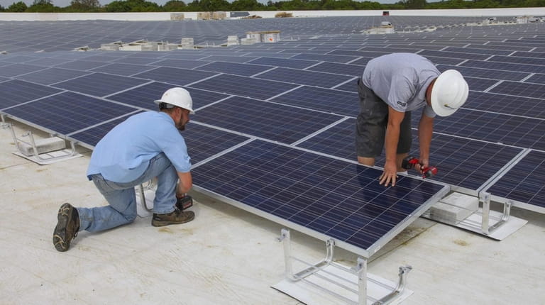 Workers from SUNation Solar Systems of Oakdale have completed a...