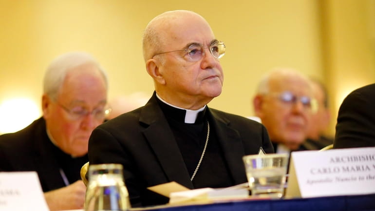 Archbishop Carlo Maria Vigano, Apostolic Nuncio to the U.S., listens...