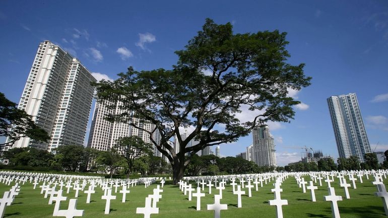 Crosses dot the Manila American Cemetery in Taguig city, east...