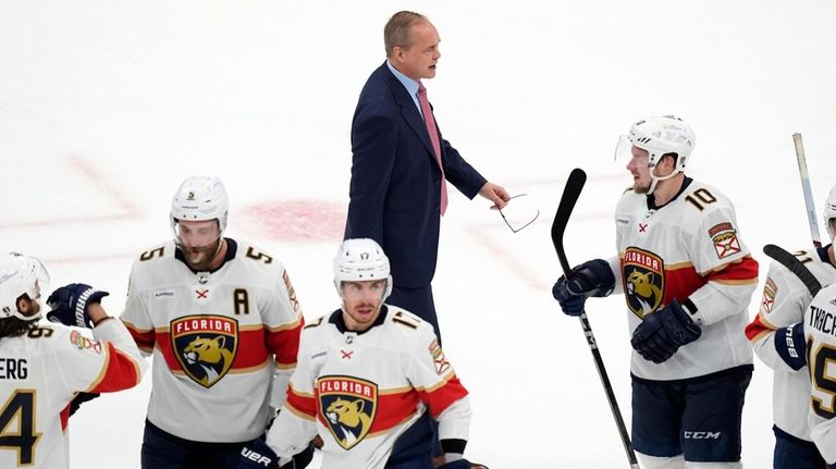 Florida Panthers head coach Paul Maurice, top, walks behind his...