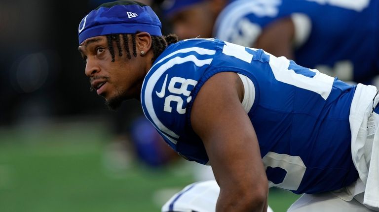 Indianapolis Colts running back Jonathan Taylor stretches before a preseason...