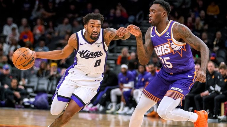 Sacramento Kings' Malik Monk (0) drives around against Phoenix Suns'...