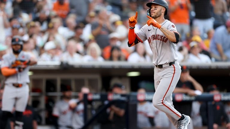 San Francisco Giants' Grant McCray celebrates after hitting a three-run...