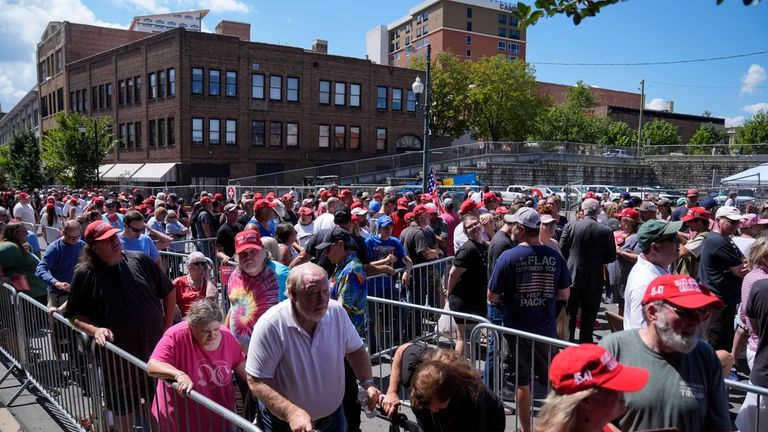 People wait to line to attend campaign rally with Republican...