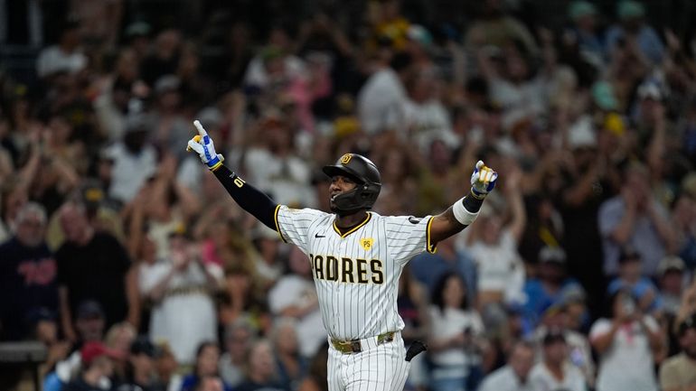 San Diego Padres' Jurickson Profar celebrates after hitting a three-run...