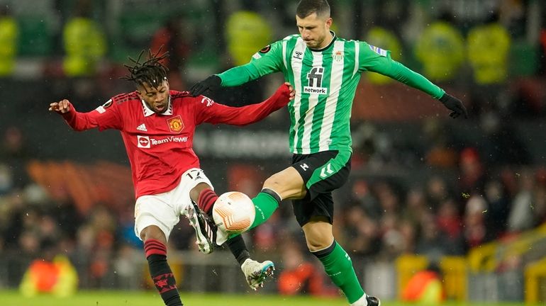 Manchester United's Fred, left, is challenged by Betis' Guido Rodriguez...