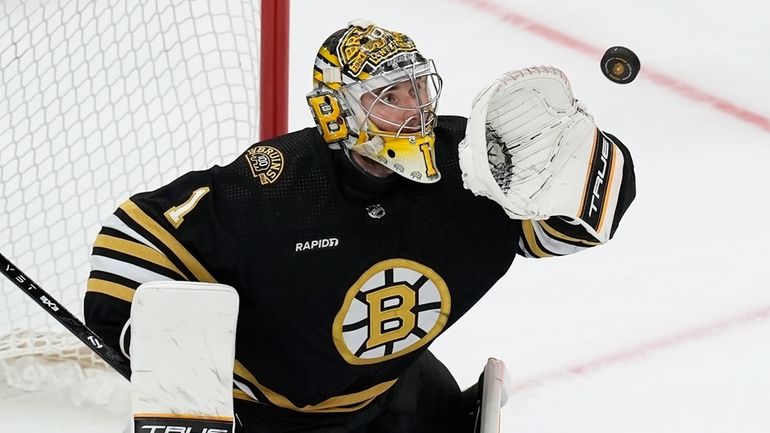 Boston Bruins' Jeremy Swayman makes a glove save during the...