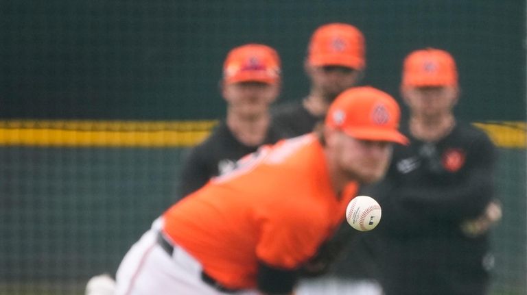 Baltimore Orioles pitcher Corbin Burnes throws during live batting practice...