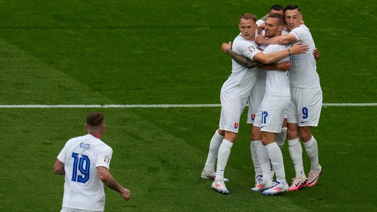 Slovakia players celebrate after teammate Slovakia's Ivan Schranz scored the...