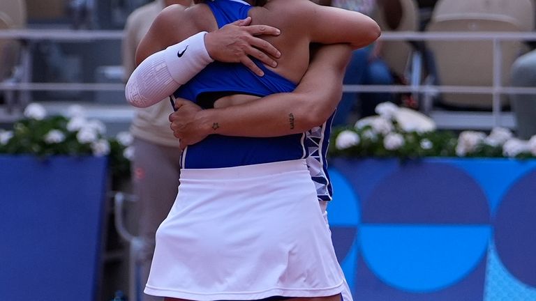 Sara Errani and Jasmine Paolini of Italy hug after they...