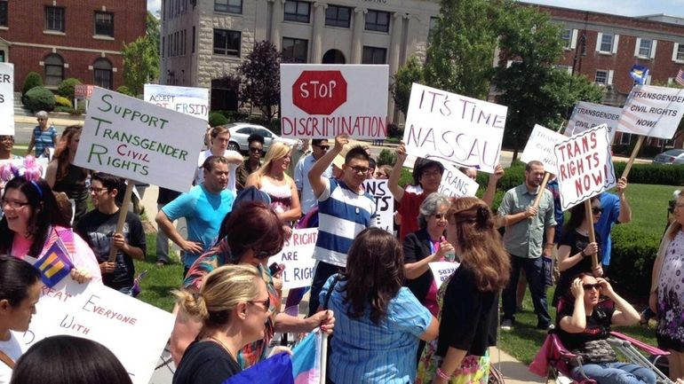 Protesters gather at the Nassau County executive and legislative building...