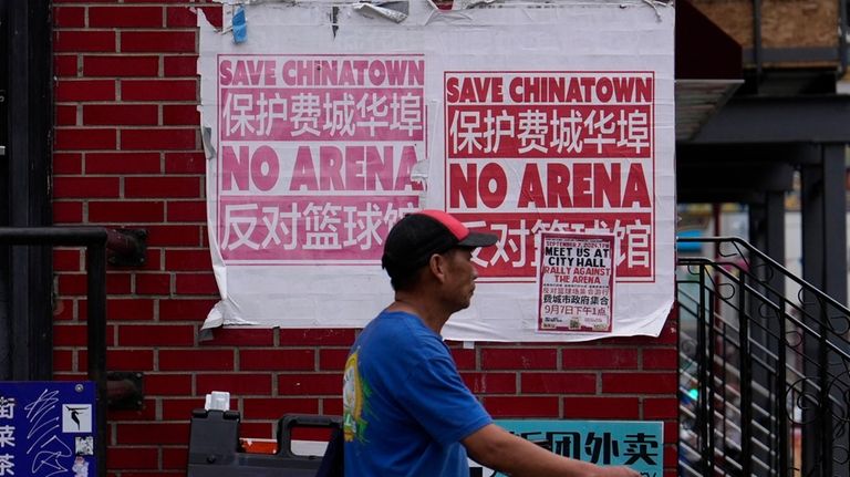 A man walks through the Chinatown neighborhood of Philadelphia, Wednesday,...