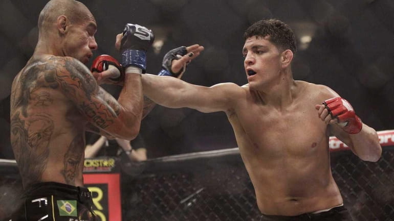 Nick Diaz, right, punches Evangelista "Cyborg" Santos, from Brazil, in...