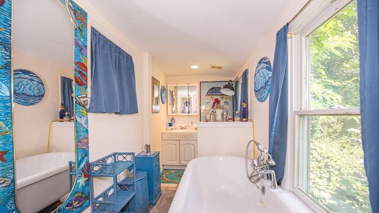 A bathroom features a clawfoot tub.