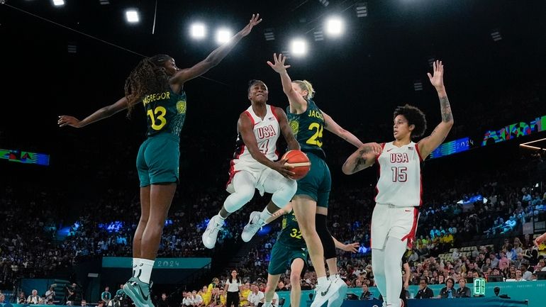 United States' Jewell Loyd (4) hangs in the air as...