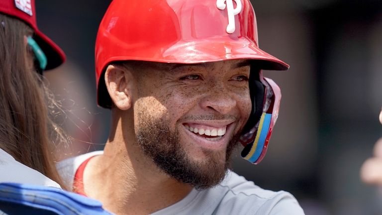 Philadelphia Phillies' Edmundo Sosa celebrates in the dugout after scoring...