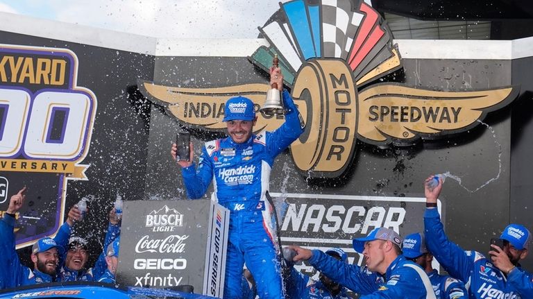 Kyle Larson celebrates after winning a NASCAR Cup Series auto...