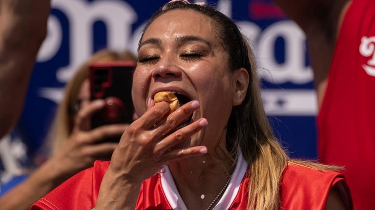 Competitive eater Miki Sudo eats a hot dog during the...