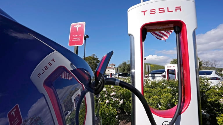 FILE — Tesla electric vehicles are seen at Tesla chargers,...