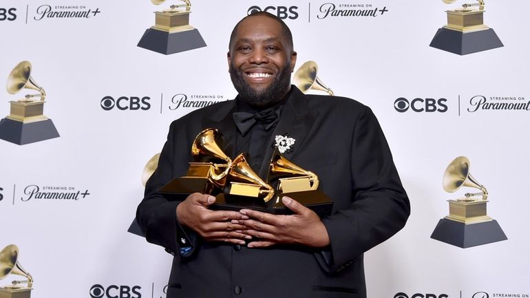 Killer Mike poses in the press room with the awards...