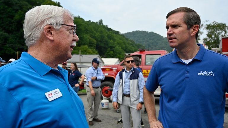 Kentucky Gov. Andy Beshear, right, speaks with John Pearce with...