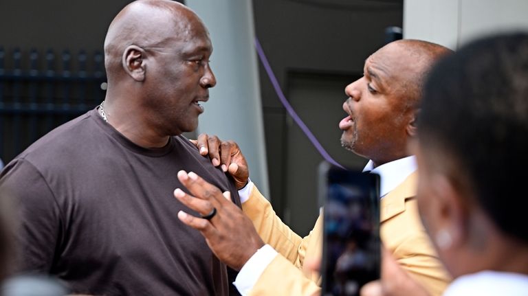 Former NFL player Dwight Freeney, right, talks with Michael Jordan,...