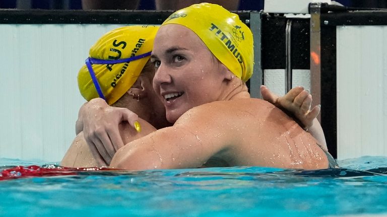 Mollie O'Callaghan, left, of Australia, is congratulated after winning the...