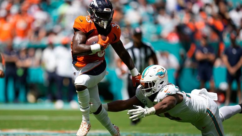 Miami Dolphins defensive tackle Christian Wilkins (94) goes after Denver...